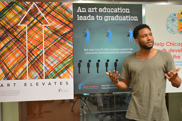 MMM student Miles Warmington presents his poster to Urban Gateways Marketing Associate Anna Joranger.