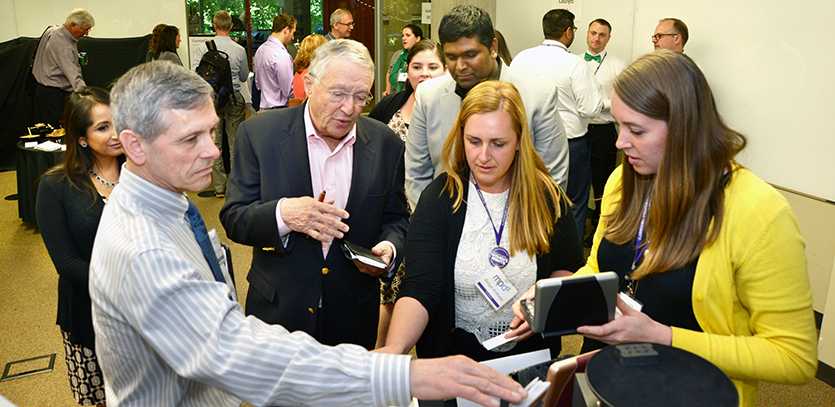 Richard Lueptow (left) and Gordon Segal (right) examine a prototype with students.