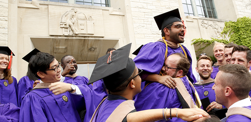 MMM graduates celebrate together outside after the ceremony.