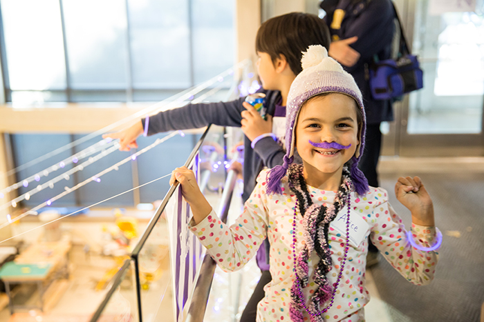 Segal faculty member Ken Gentry's daughter strikes a pose to show off her purple pride. 