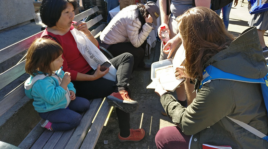 Testing the lunchbox prototype with parents and children at a farmers market.